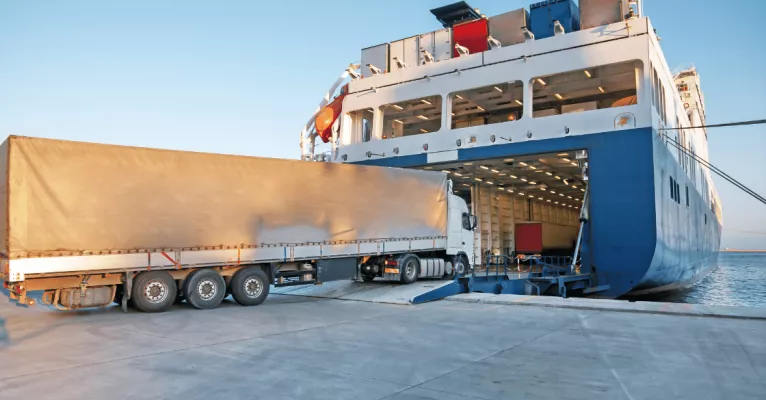 Truck driving onto container ship