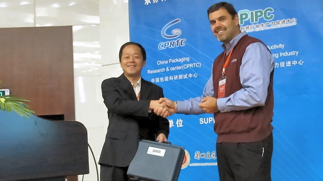 Eric Joneson presenting SAVER devices to Han Xueshan.